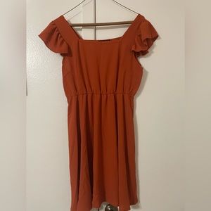 Burnt orange ruffled dress.